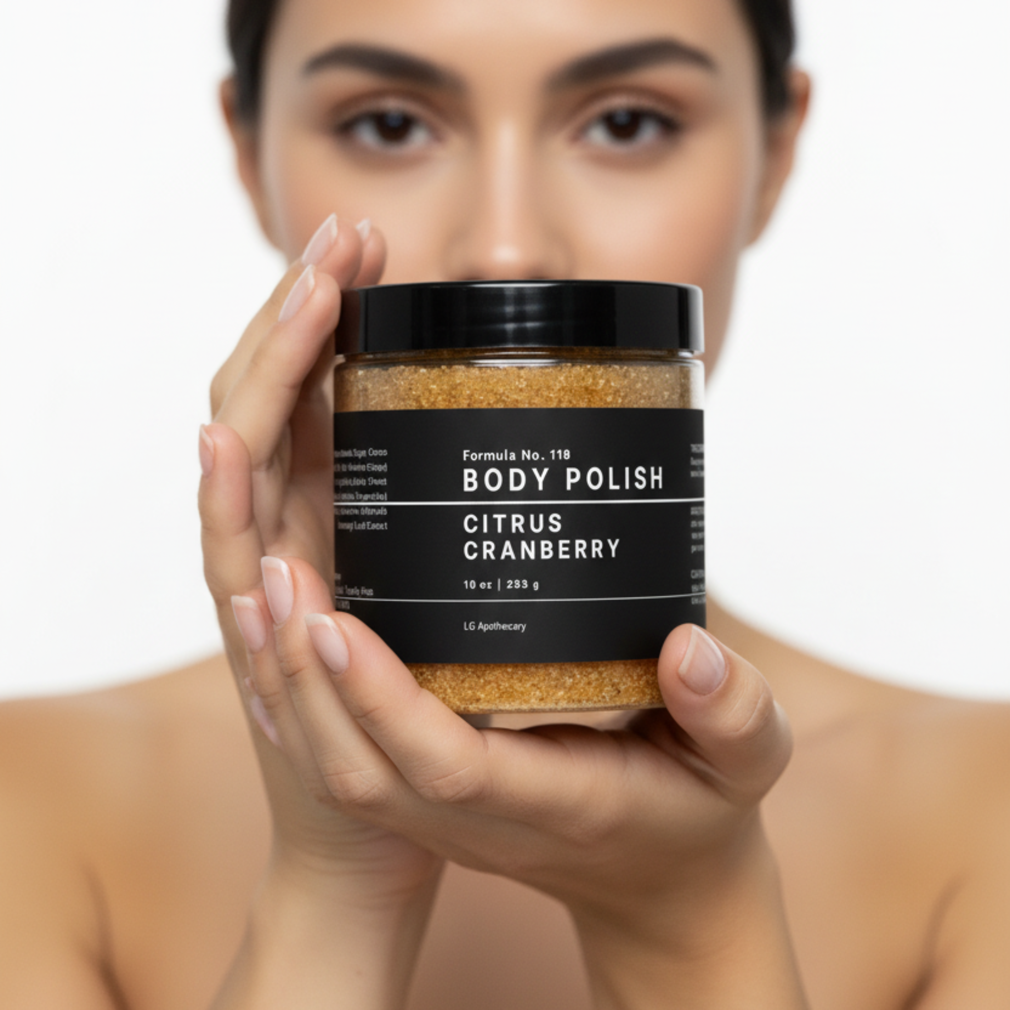Woman holding a jar of 'Body Polish Citrus Cranberry' against a white background