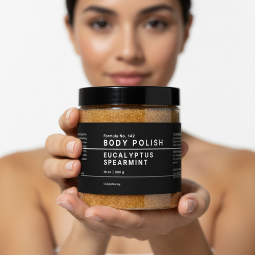 Woman holding a jar of body polish with a plain background