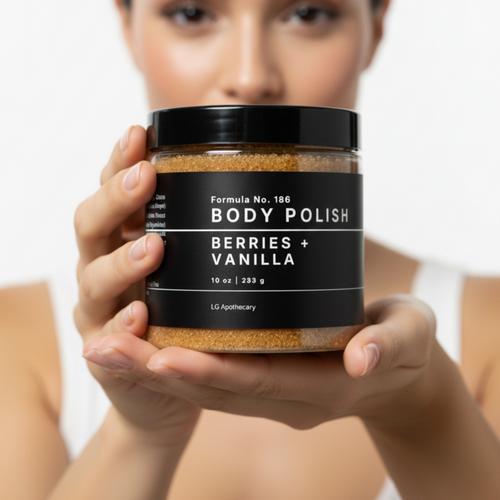 Woman holding a jar of 'Body Polish Berries + Vanilla' by LC Body Polish against a white background