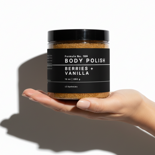 Hand holding a jar of 'Body Polish Berries + Vanilla' against a white background