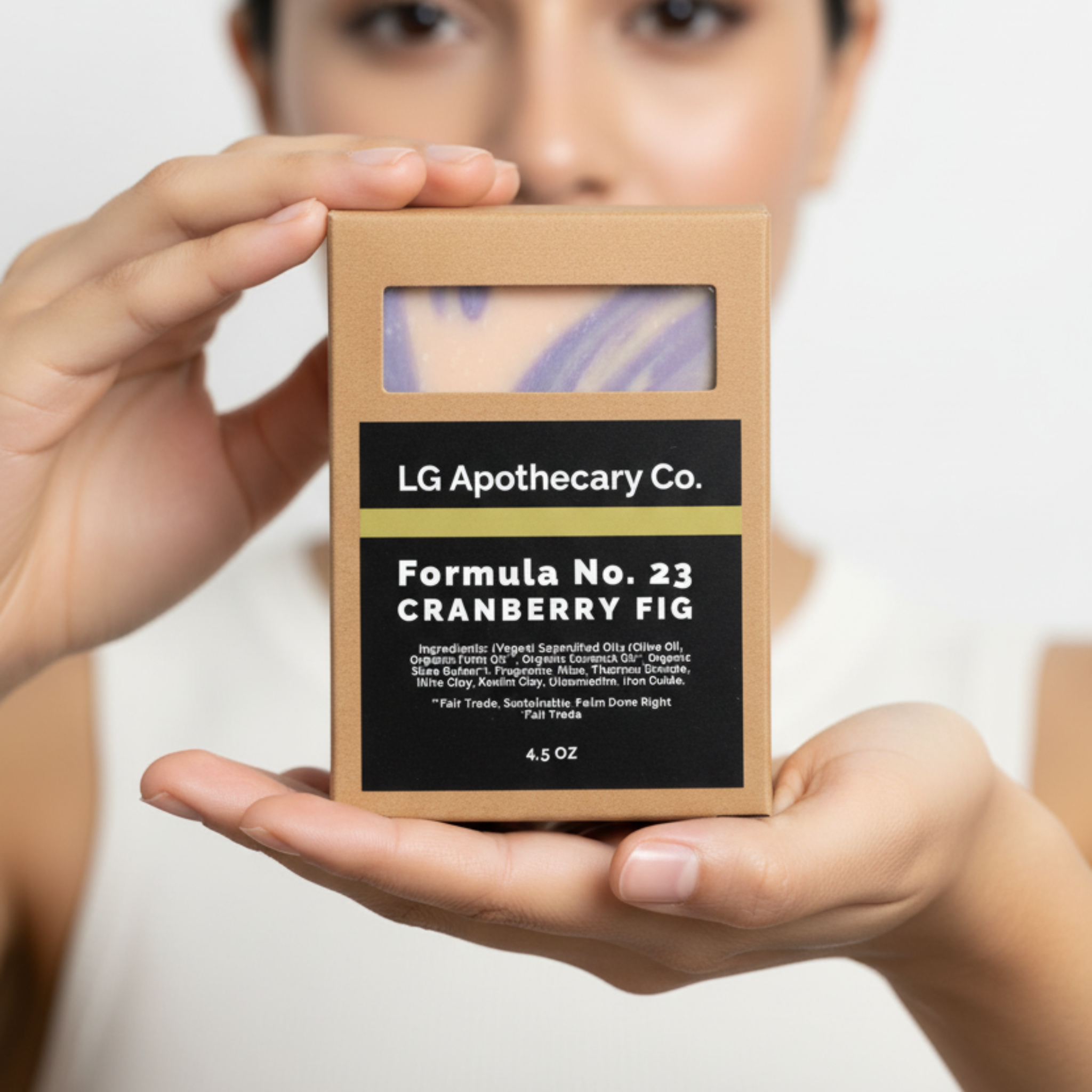 Person holding a LG Apothecary Co. product box with a plain background