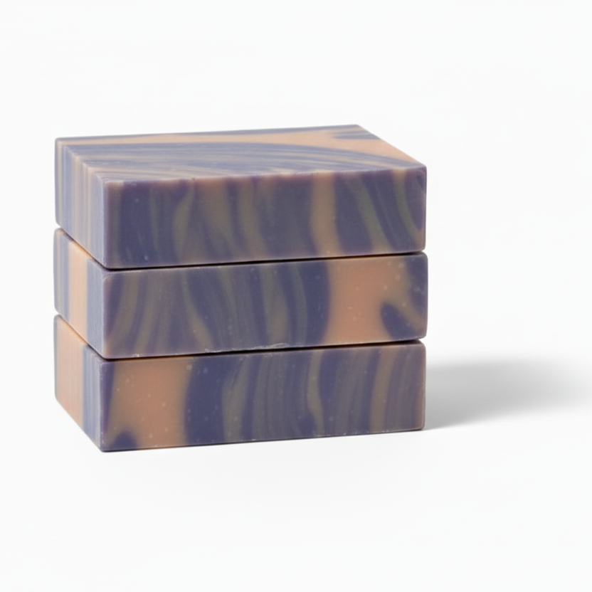Three bars of marbled soap stacked on a white background
