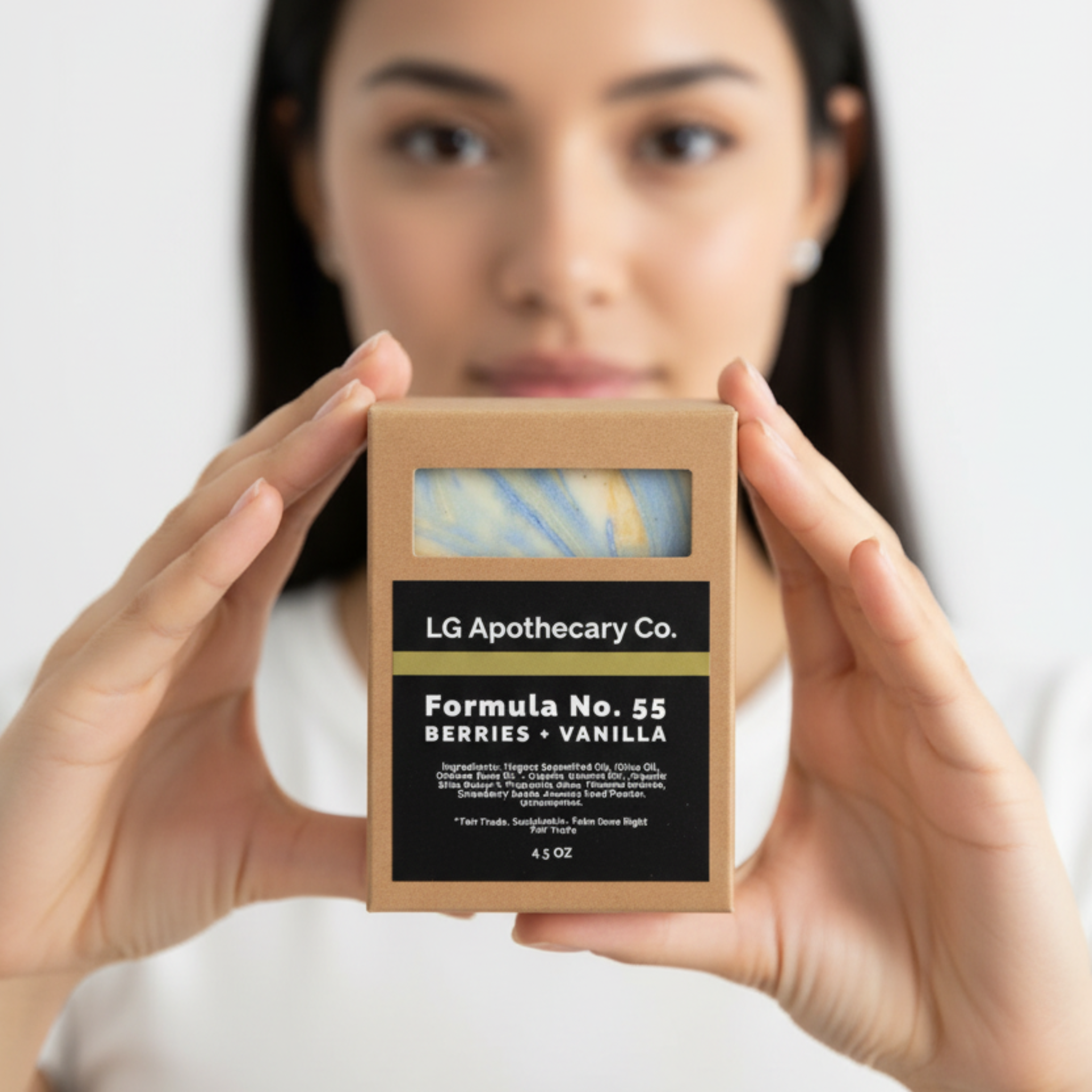 Person holding a box of LG Apothecary Co. product against a white background