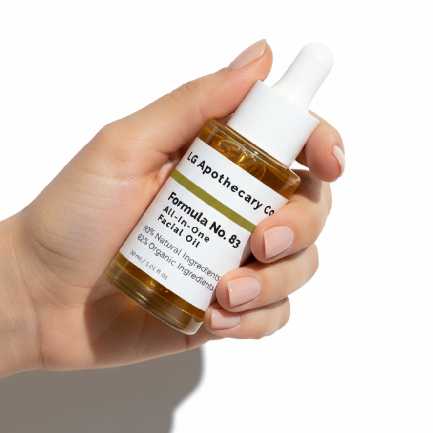 Hand holding a bottle of LG Apothecary Co. facial oil against a white background