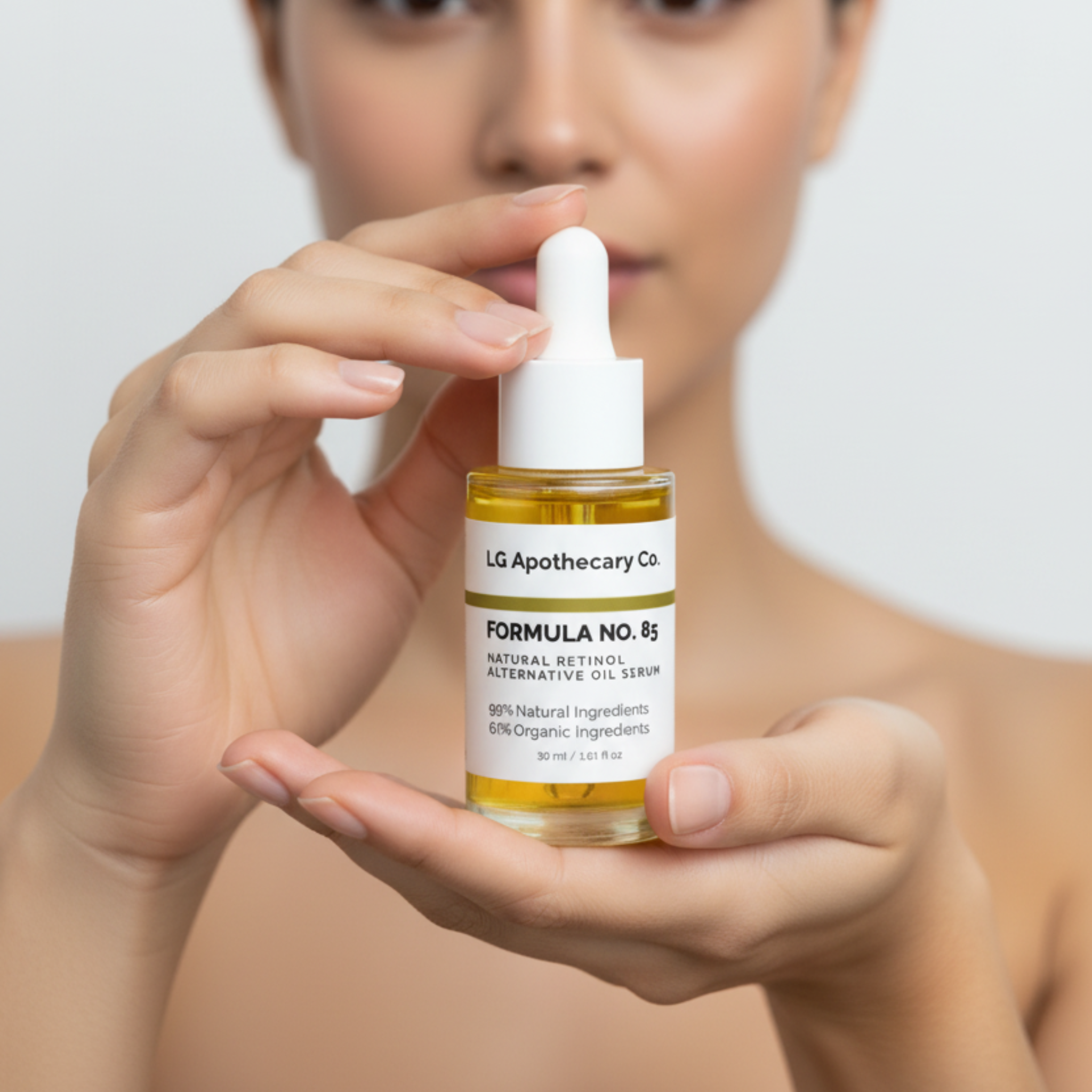 Woman holding a bottle of LG Apothecary Co. skincare product against a plain background