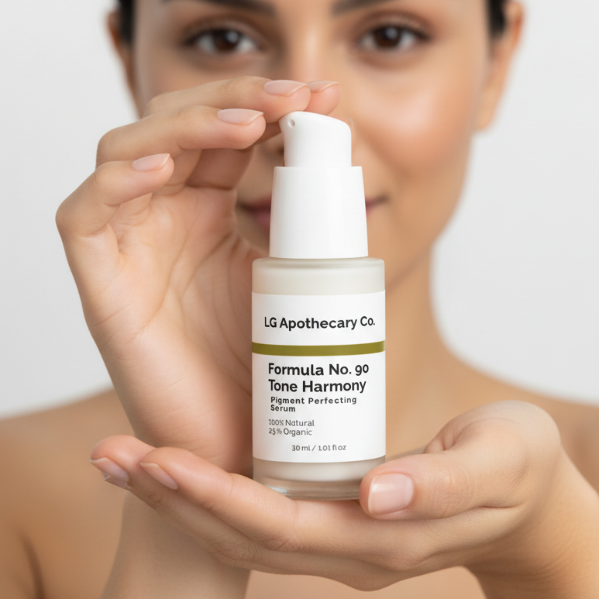 Person holding a skincare bottle labeled 'LG Apothecary Co.' with a plain background