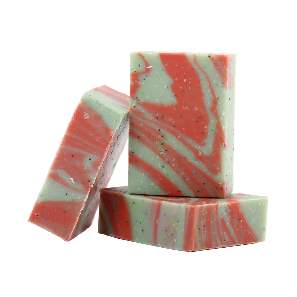 Three bars of swirled soap in red and green on a white background